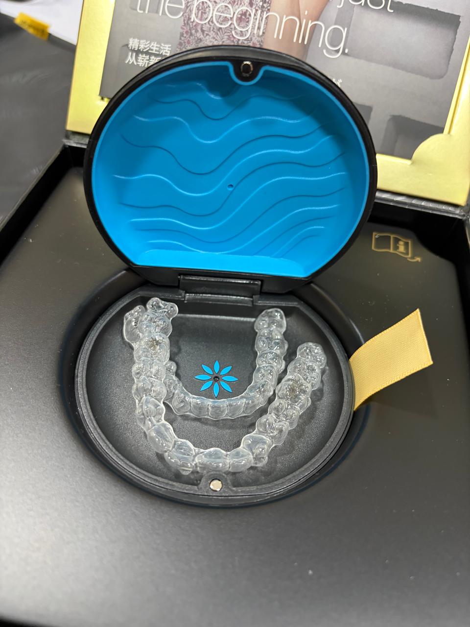 A clear Invisalign aligner tray in its case